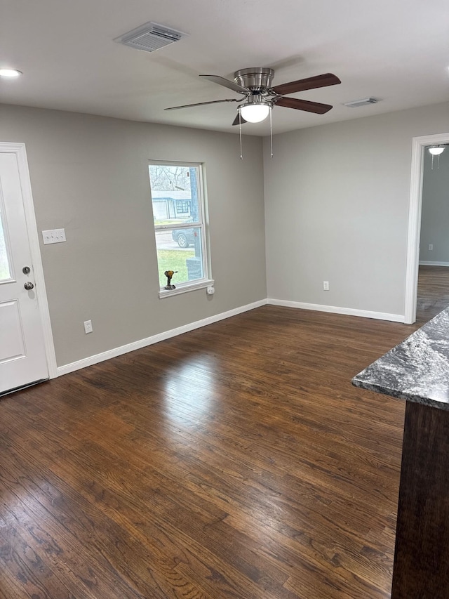 spare room featuring ceiling fan and dark hardwood / wood-style flooring