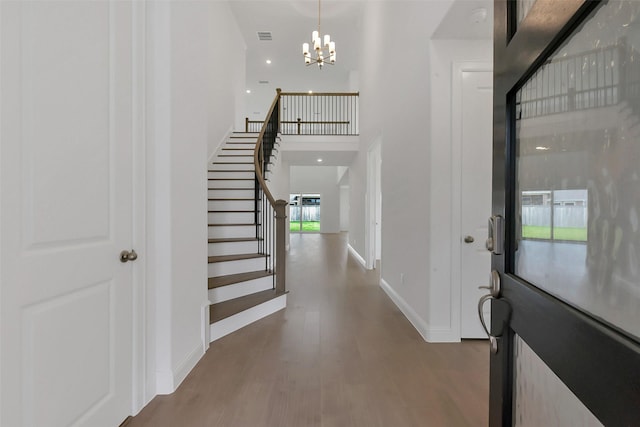 13115 Brookwood Bend Ln, Conroe, TX 77302 - entrance foyer with stairway, wood finished floors, baseboards, a towering ceiling, and a chandelier