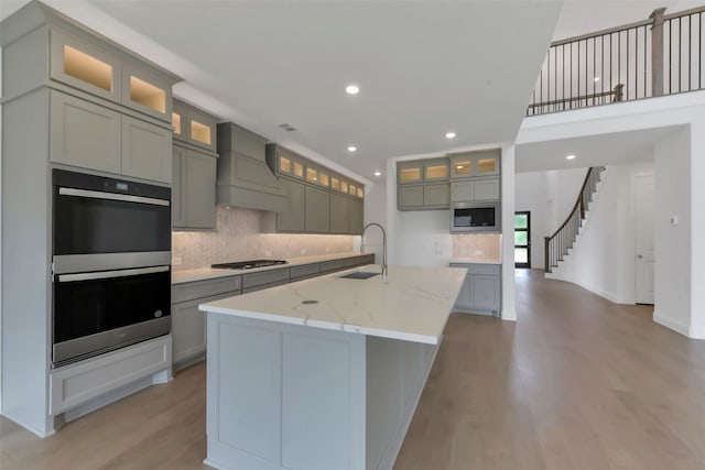 13115 Brookwood Bend Ln, Conroe, TX 77302 - kitchen featuring custom range hood, a sink, stainless steel appliances, decorative backsplash, and recessed lighting
