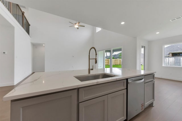 13115 Brookwood Bend Ln, Conroe, TX 77302 - kitchen with stainless steel dishwasher, a sink, plenty of natural light, a ceiling fan, and recessed lighting