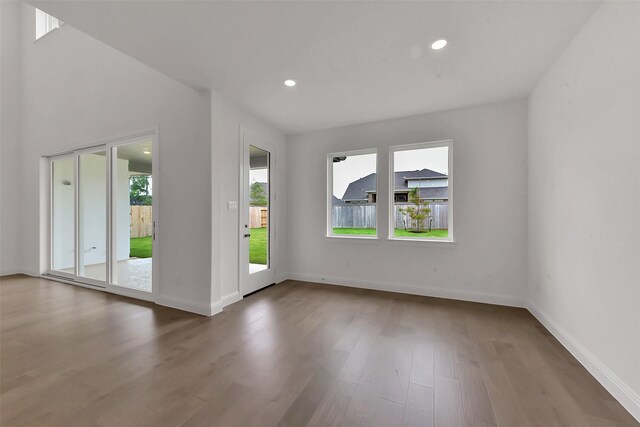 13115 Brookwood Bend Ln, Conroe, TX 77302 - unfurnished living room featuring wood finished floors, baseboards, and recessed lighting