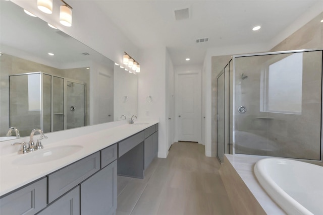 13115 Brookwood Bend Ln, Conroe, TX 77302 - full bathroom with a stall shower, double vanity, a garden tub, recessed lighting, and tile patterned floors