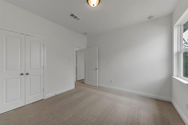 13115 Brookwood Bend Ln, Conroe, TX 77302 - unfurnished bedroom featuring light colored carpet, a closet, and baseboards