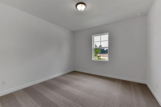 13115 Brookwood Bend Ln, Conroe, TX 77302 - carpeted empty room with baseboards