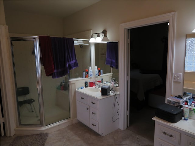 bathroom with tile patterned floors, walk in shower, and vanity