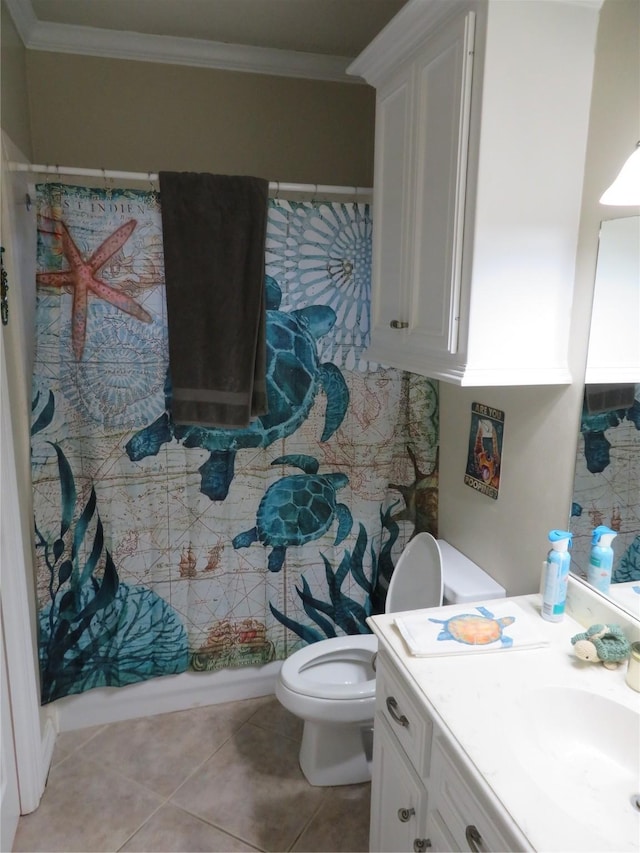 bathroom with toilet, vanity, tile patterned floors, and crown molding