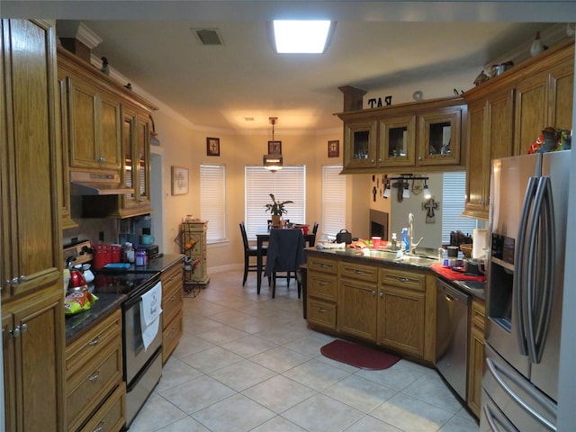 kitchen featuring light tile patterned floors, appliances with stainless steel finishes, pendant lighting, crown molding, and sink