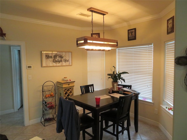 dining area featuring light tile patterned floors and ornamental molding