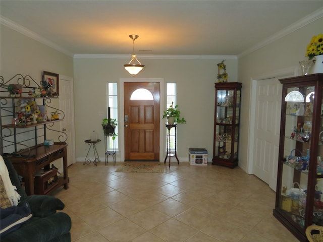 foyer with light tile patterned floors and ornamental molding