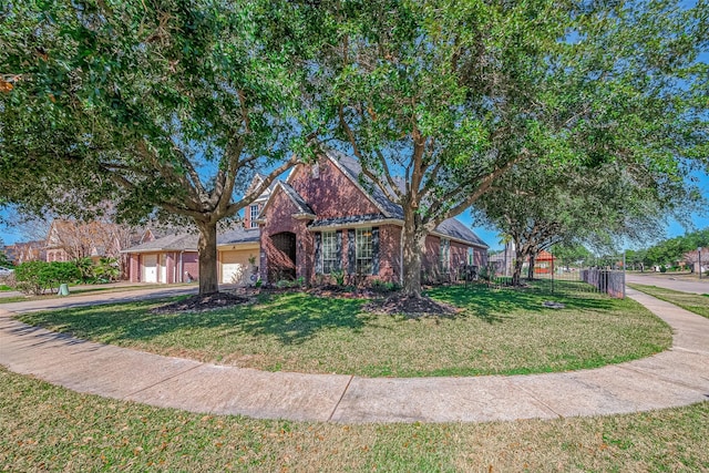 view of front of property with a front lawn and a garage