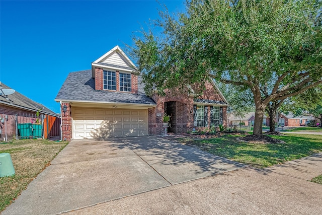 view of front of home with a front yard and a garage