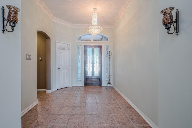 entryway featuring an inviting chandelier and ornamental molding