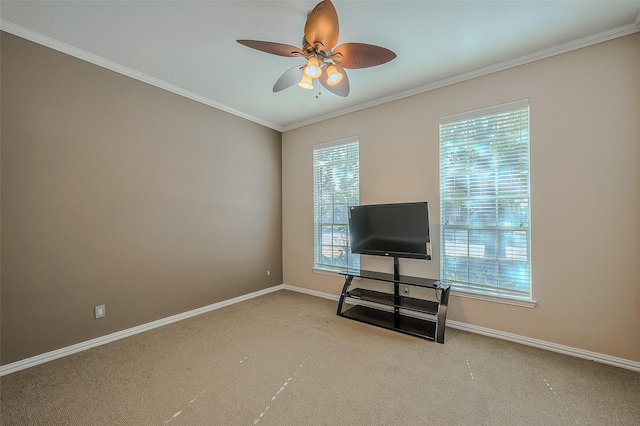 interior space with ceiling fan, light colored carpet, and ornamental molding