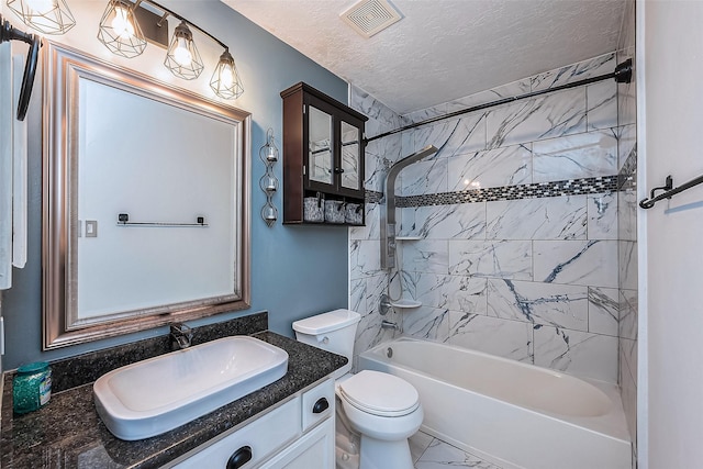 full bathroom featuring a textured ceiling, toilet, vanity, and tiled shower / bath