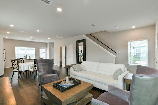 living room featuring a wealth of natural light and dark hardwood / wood-style flooring