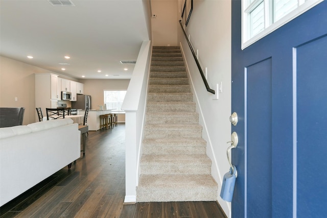 stairway with hardwood / wood-style flooring