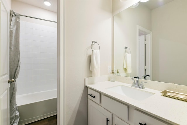 bathroom featuring shower / bathtub combination, hardwood / wood-style flooring, and vanity