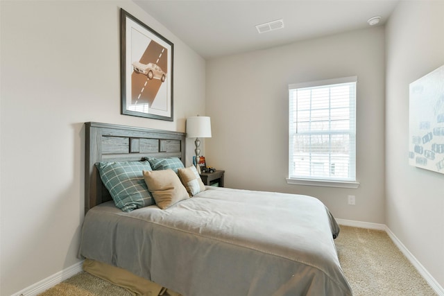 bedroom featuring multiple windows and carpet flooring