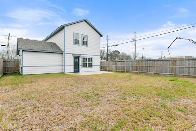 rear view of property featuring a patio area and a lawn