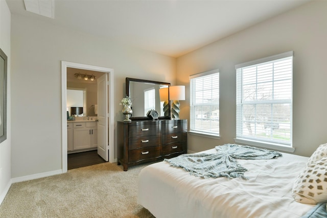 carpeted bedroom with connected bathroom