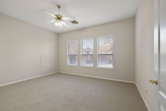 carpeted spare room with ceiling fan