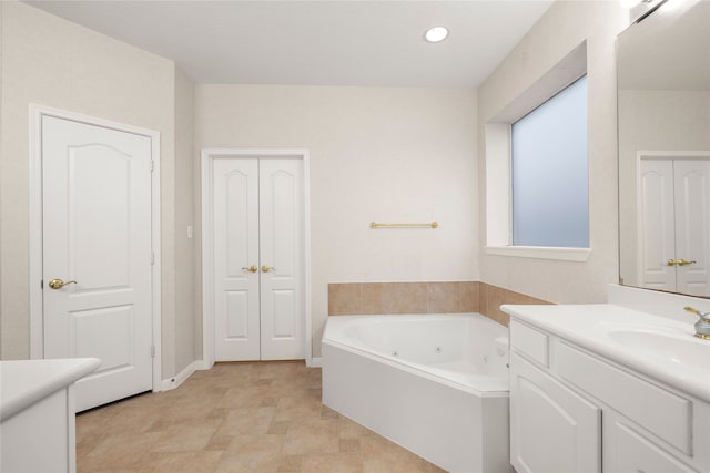 bathroom featuring vanity and a tub to relax in