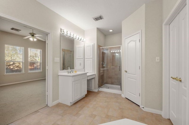 bathroom featuring a shower with door, vanity, and ceiling fan