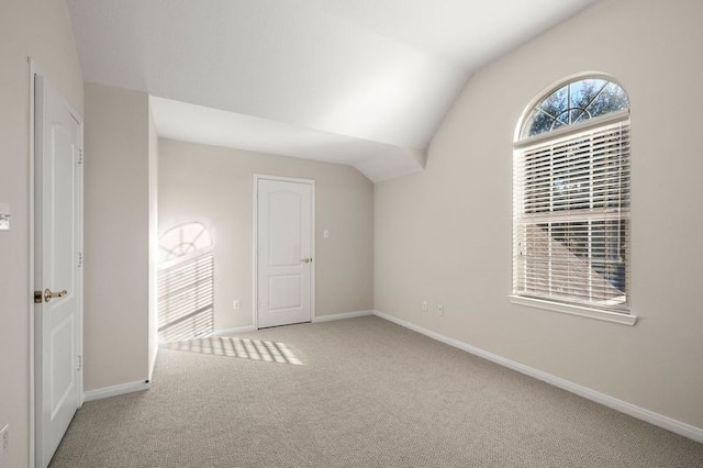 interior space with lofted ceiling and carpet