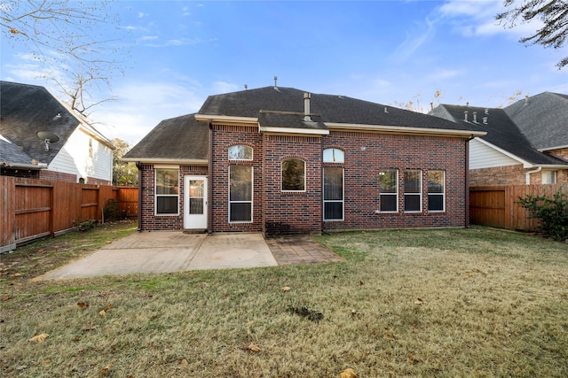 back of house with a yard and a patio