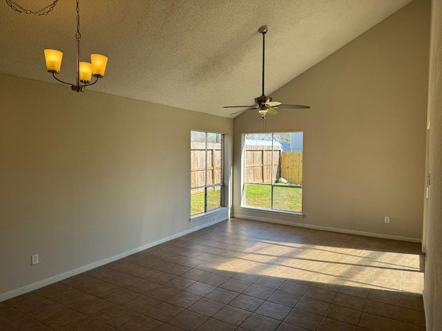 empty room featuring tile patterned flooring, ceiling fan with notable chandelier, high vaulted ceiling, and a textured ceiling