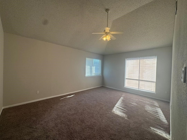 carpeted empty room with ceiling fan, lofted ceiling, and a textured ceiling