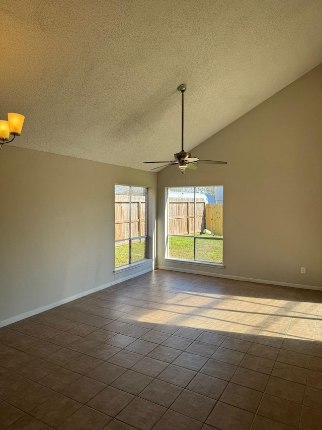 tiled spare room with lofted ceiling, a textured ceiling, and ceiling fan