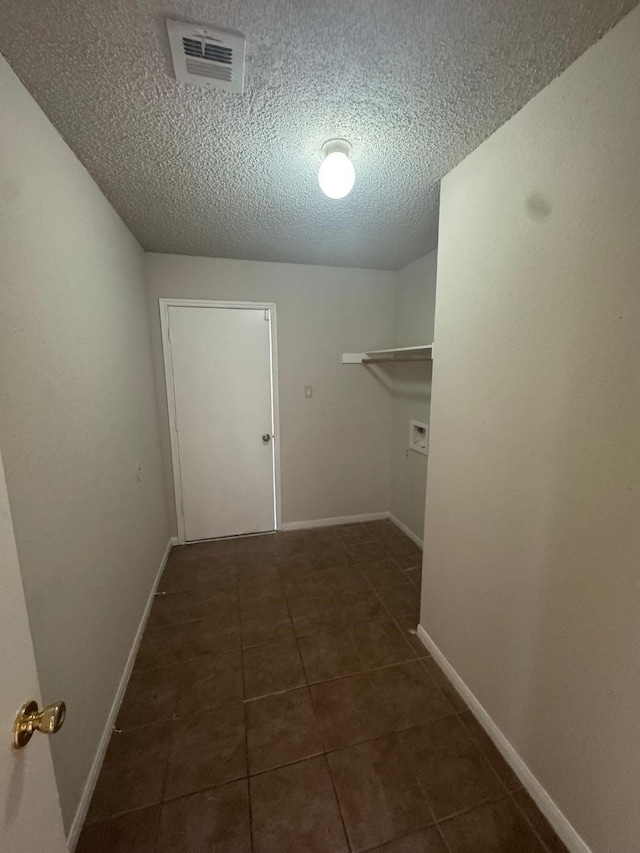 walk in closet featuring dark tile patterned flooring