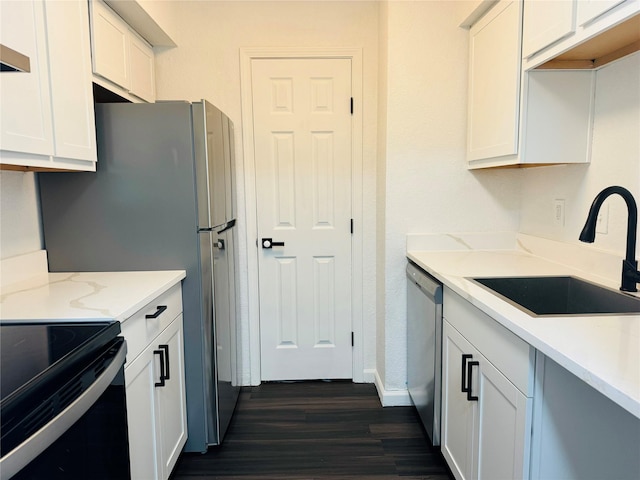 kitchen with white cabinets, dark wood-type flooring, sink, light stone counters, and stainless steel dishwasher