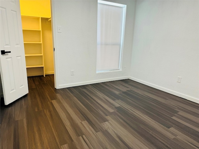 unfurnished room featuring dark hardwood / wood-style flooring