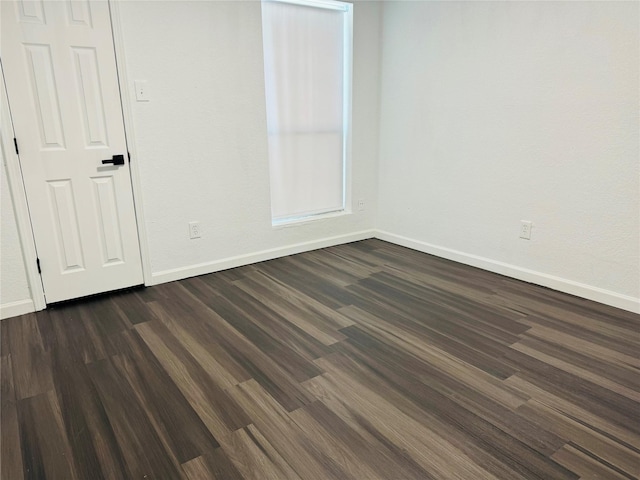 spare room featuring dark hardwood / wood-style flooring