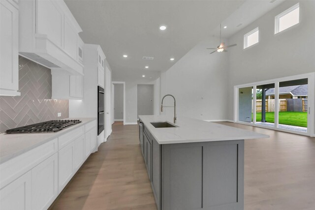 16163 Sheridan River Trl, Conroe, TX 77302 - kitchen featuring a sink, stainless steel gas stovetop, open floor plan, ceiling fan, and recessed lighting