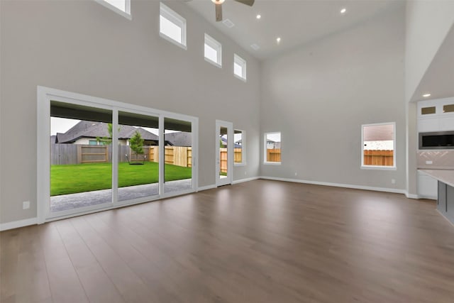 16163 Sheridan River Trl, Conroe, TX 77302 - unfurnished living room featuring a high ceiling, a ceiling fan, wood finished floors, baseboards, and recessed lighting