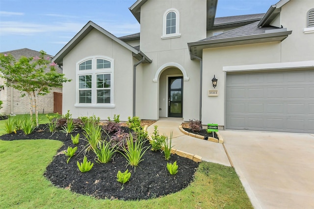 16163 Sheridan River Trl, Conroe, TX 77302 - view of front facade featuring stucco siding, concrete driveway, and a garage