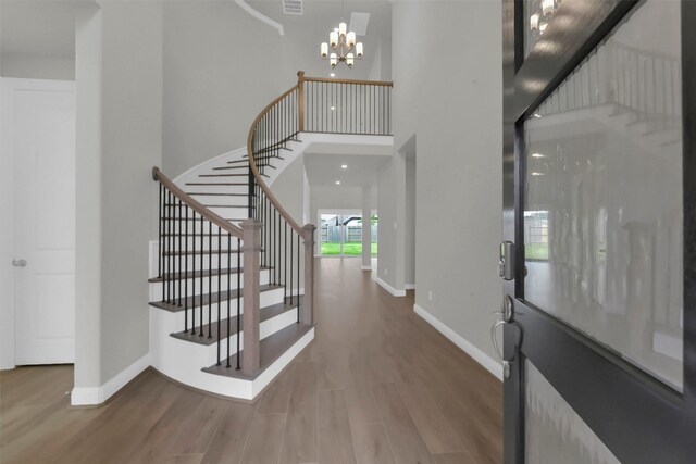 16163 Sheridan River Trl, Conroe, TX 77302 - entryway featuring a towering ceiling, wood finished floors, baseboards, and stairs