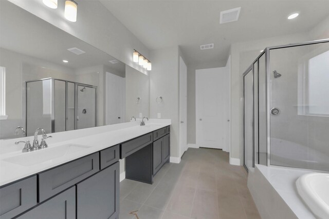 16163 Sheridan River Trl, Conroe, TX 77302 - bathroom featuring a shower stall, double vanity, baseboards, tile patterned flooring, and a tub to relax in