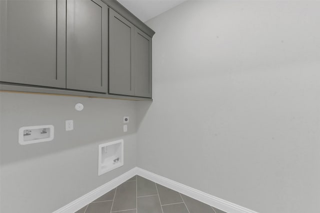16163 Sheridan River Trl, Conroe, TX 77302 - washroom with hookup for an electric dryer, cabinet space, baseboards, hookup for a washing machine, and dark tile patterned flooring