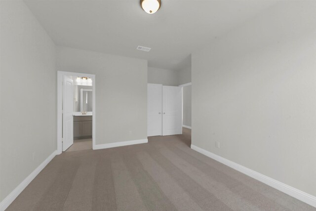 16163 Sheridan River Trl, Conroe, TX 77302 - unfurnished bedroom with carpet flooring, baseboards, and connected bathroom