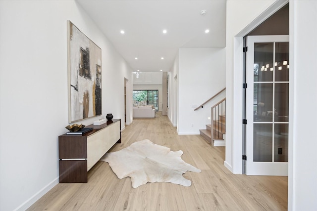 hallway with light hardwood / wood-style floors