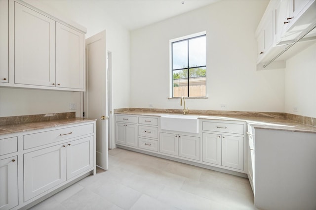 kitchen featuring white cabinets and sink