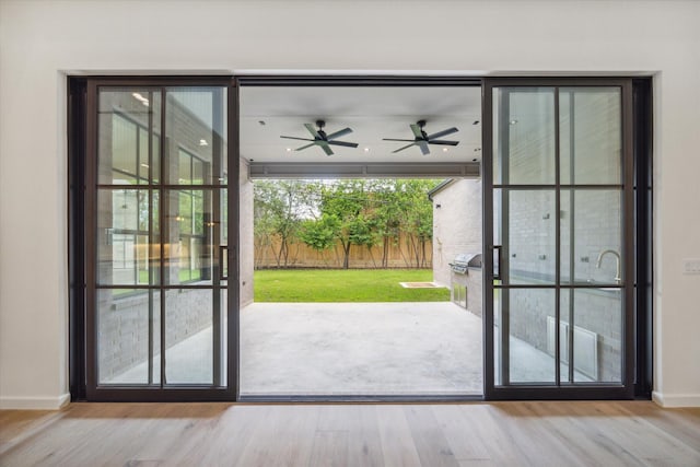 entryway featuring ceiling fan and light wood-type flooring