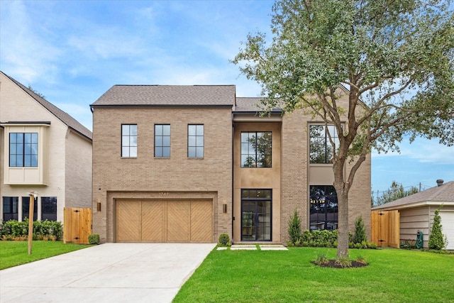 view of front facade featuring a garage and a front lawn