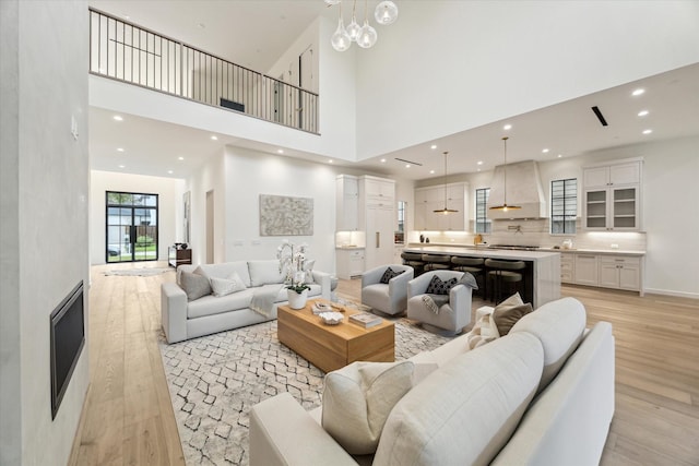 living room featuring light hardwood / wood-style floors and a high ceiling