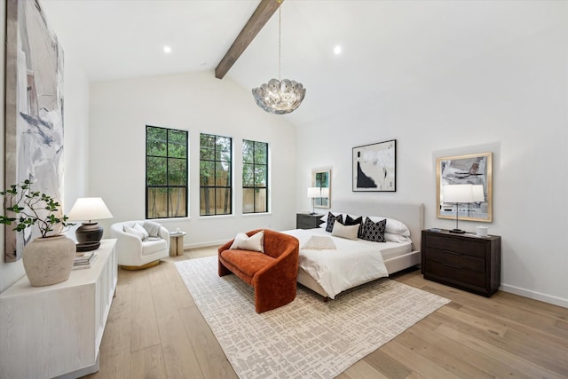 bedroom with beam ceiling, light wood-type flooring, an inviting chandelier, and high vaulted ceiling