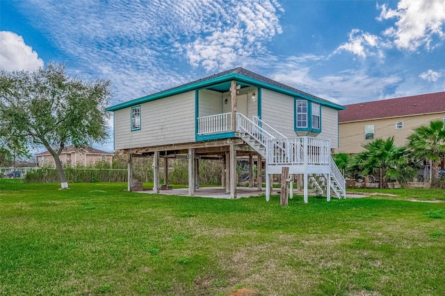 rear view of property featuring a yard and a patio